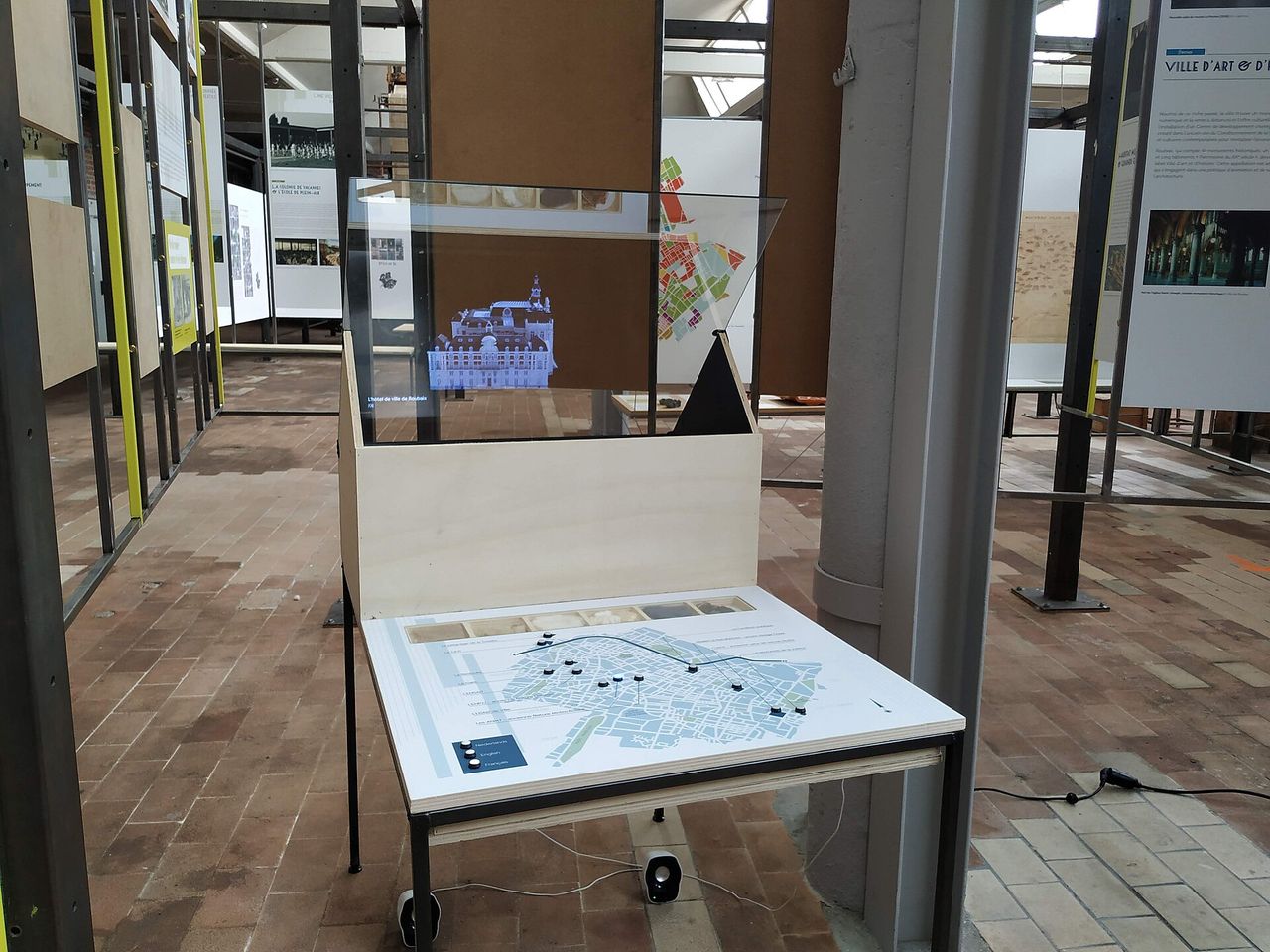 Interactive table and hologram display in an exhibition space.