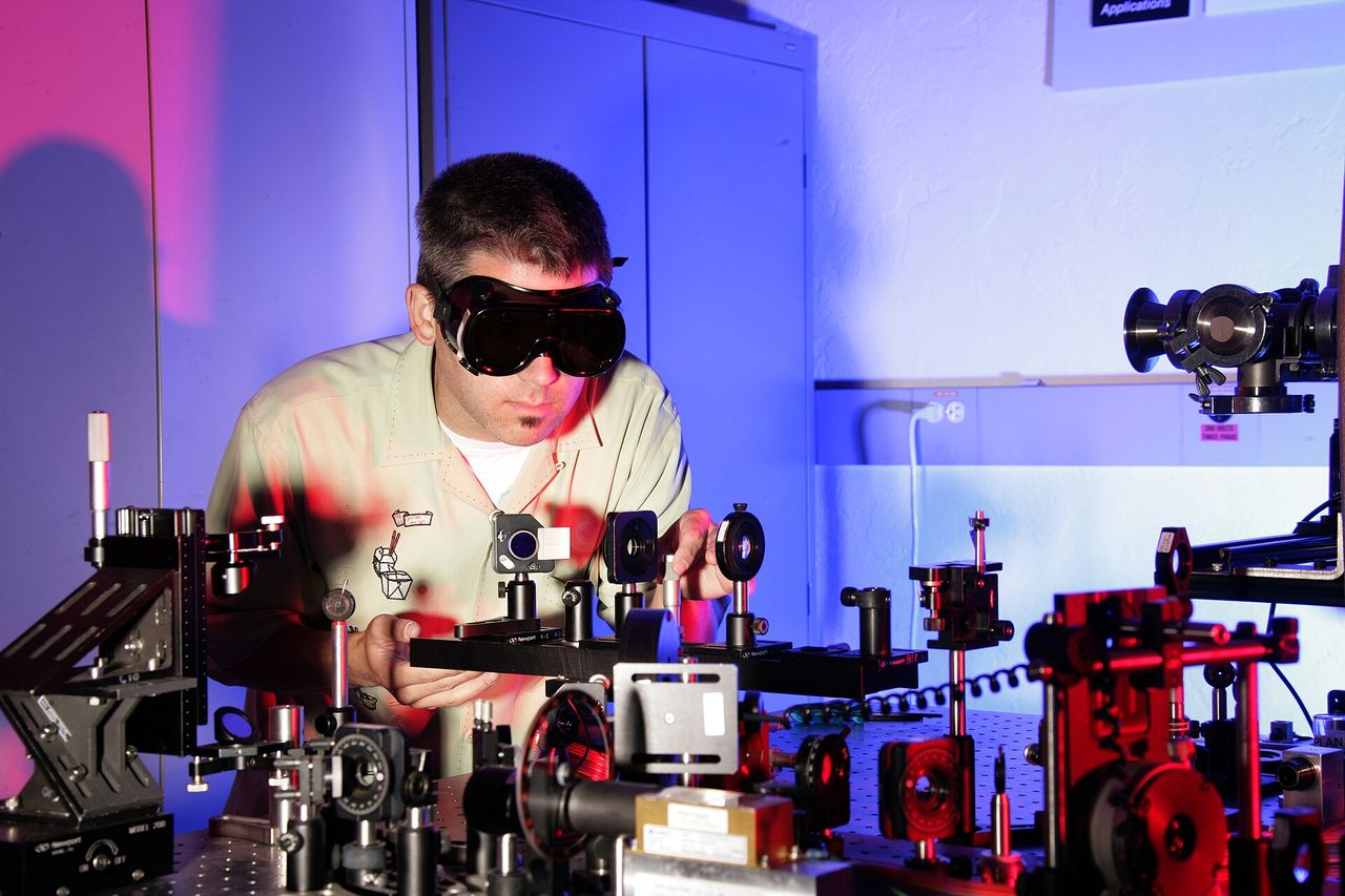 Optical table with laser beams and components used in holographic recording and optical processing.