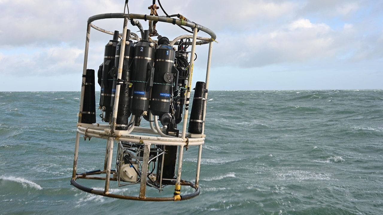 A CTD instrument measuring conductivity, temperature and depth lowered into the sea for oceanographic monitoring.