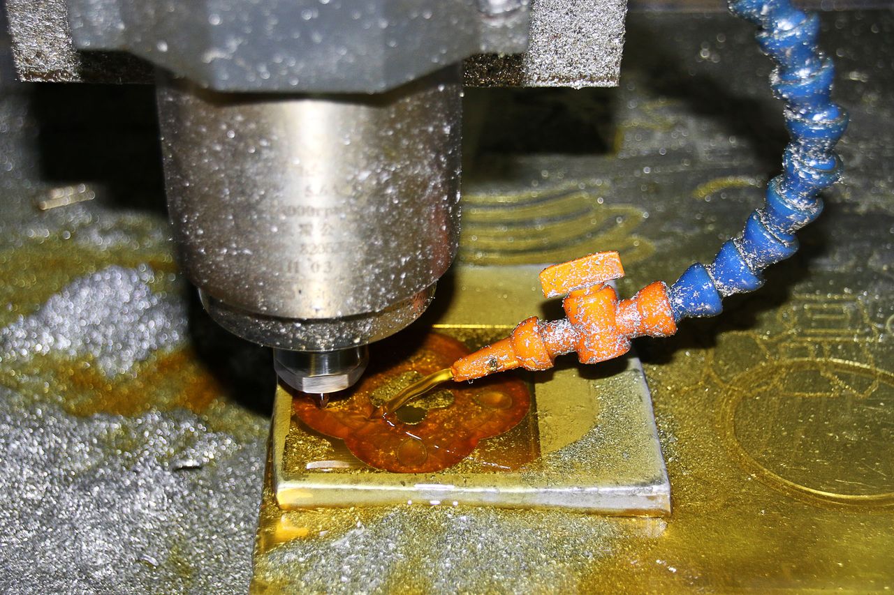 Close-up of a CNC milling cutter machining a metal part in a precision machine.
