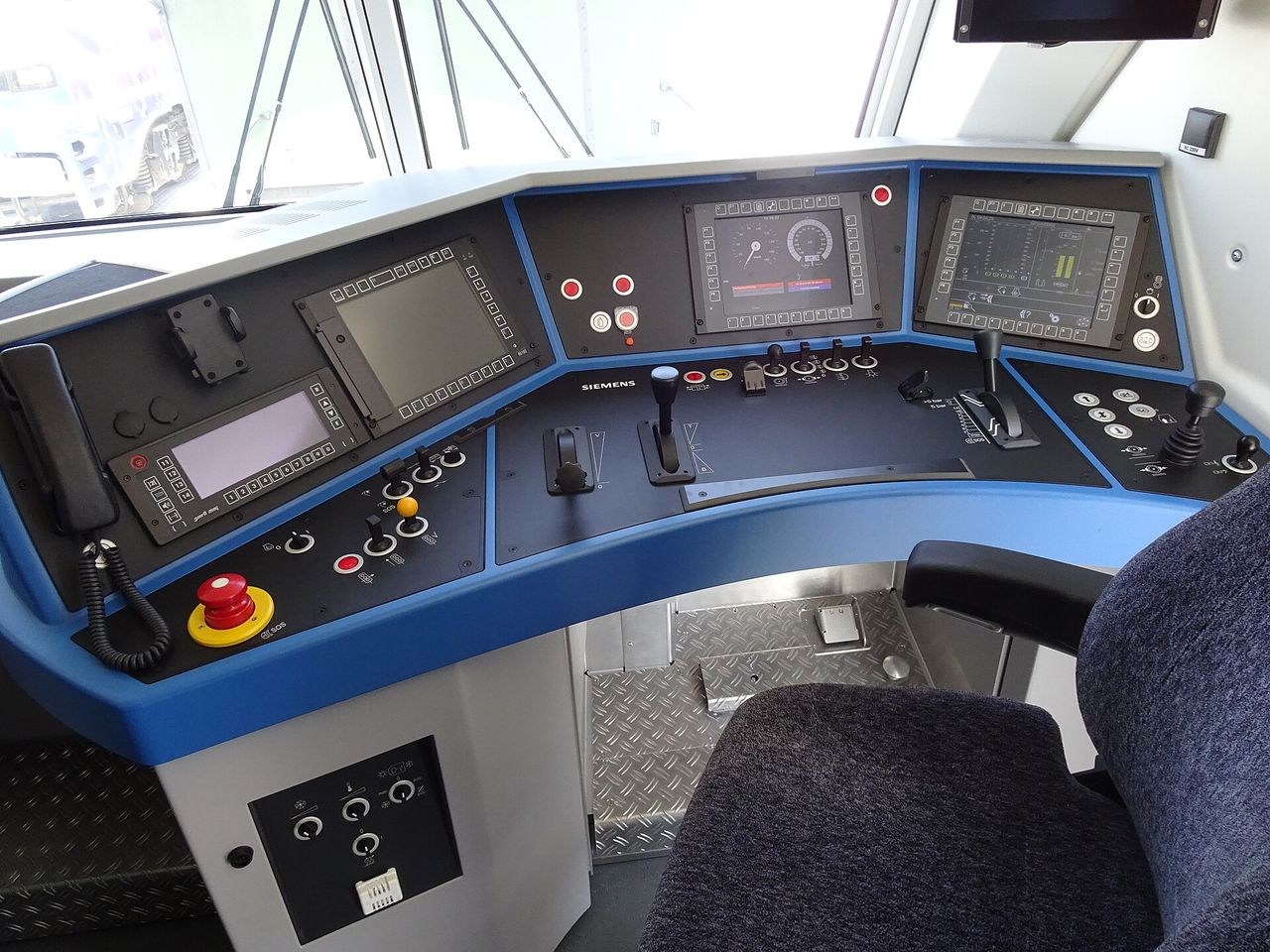Control panel in a modern locomotive cab, illustrating railway operations training.