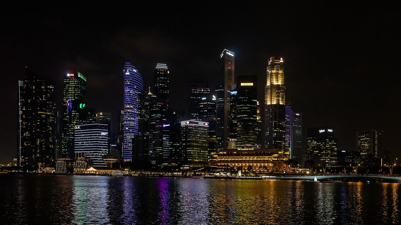 Singapore at night, with waterfront infrastructure and public space.