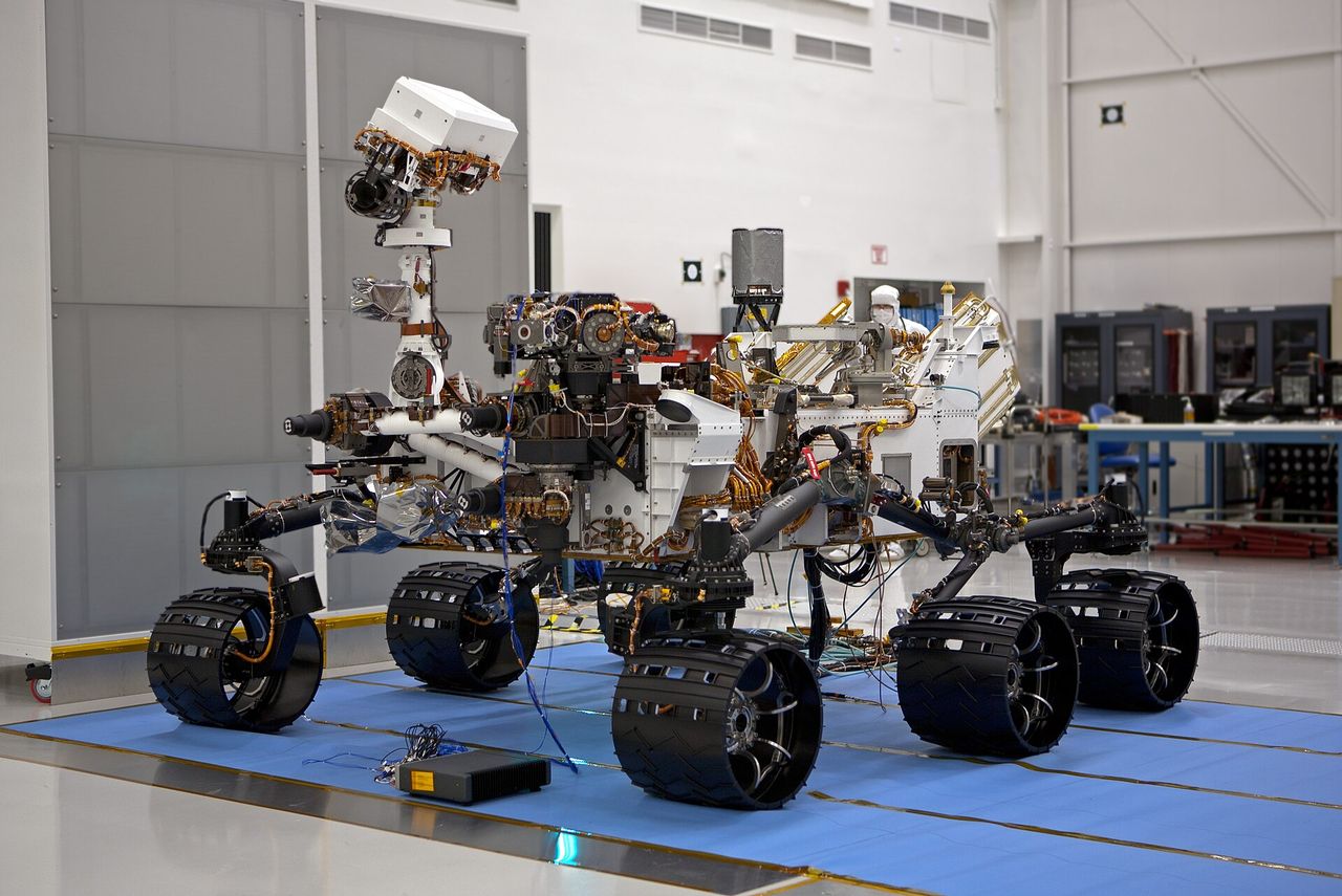 The Curiosity rover being assembled and tested in a NASA clean room.